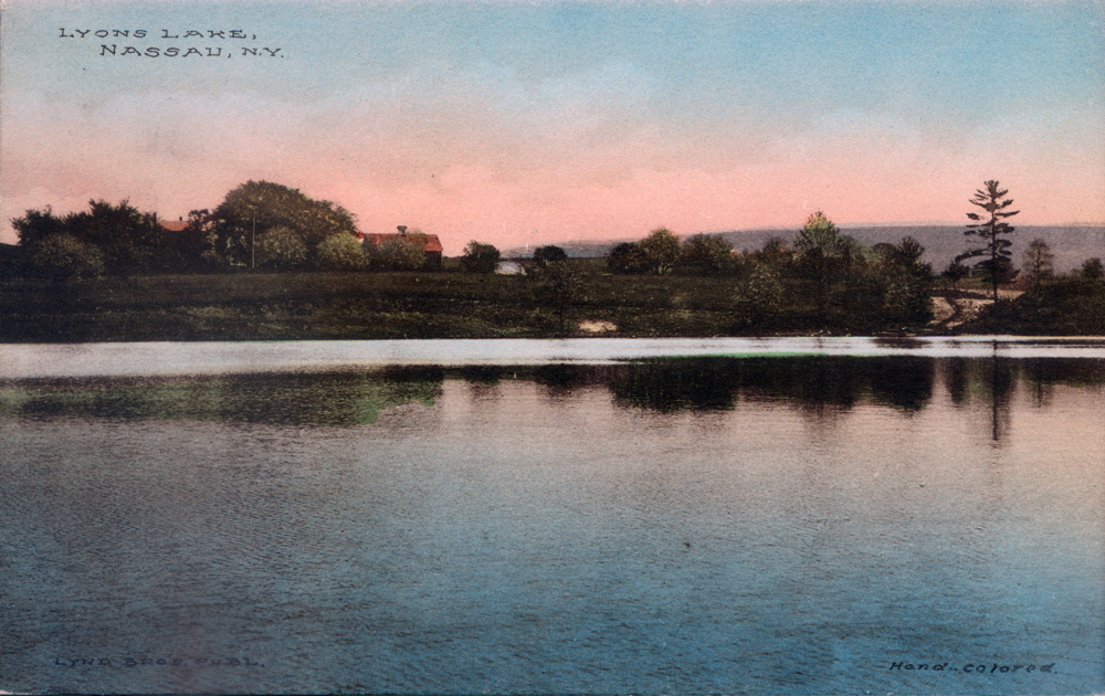 Historical Lyons Lake Postcard Hand colored B&W photograph View across lake from camps Shows Boarding House and Farm House before dance hall, ice shed (boat house) or pavilion Not Dated