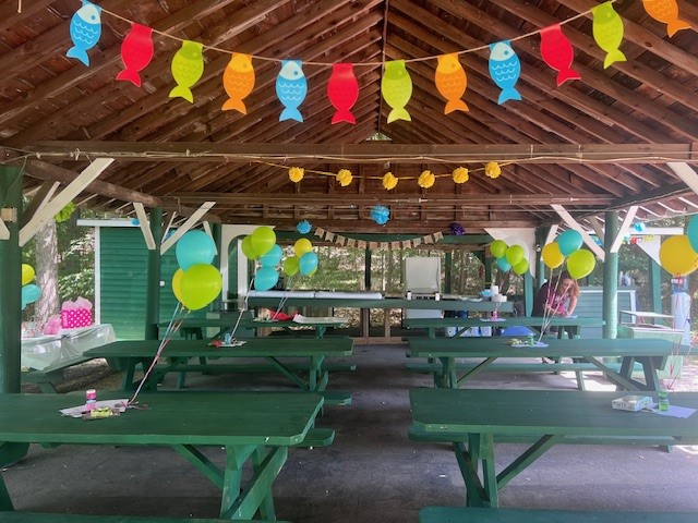 indoor photo of party pavilion with picnic tables